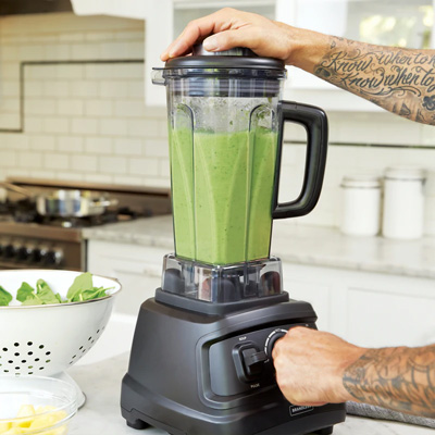 A blender filled with a green liquid