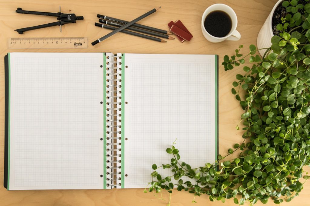 kratom studies book on desk with plant and coffee