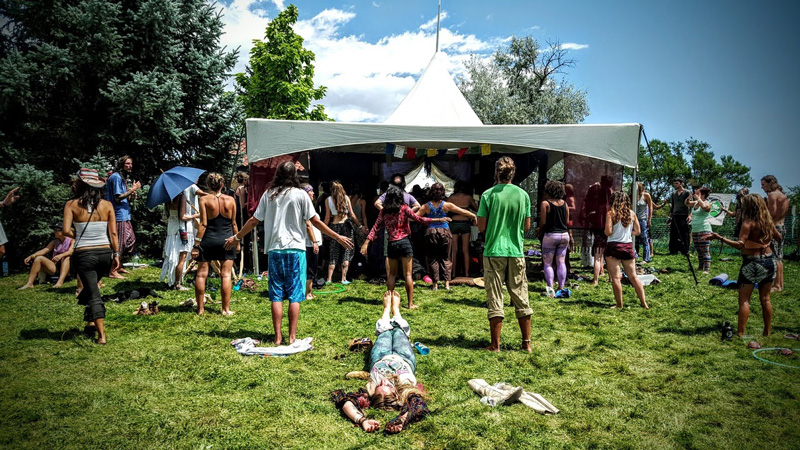 outside tent with hippies around